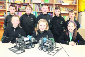 Eimear Ni Briotuin Eabha Ni Shuilleabhain, Isabela Ni Mahthuna, Cathal O Siochain, Josh O hEarcain, Sean O Mathuna, Sam Copps and Ben O Conchubhair pictured with their robots, Robbi and Wally, who competeed in the VEX IQ Robotics Competition in Birmingham yesterday.