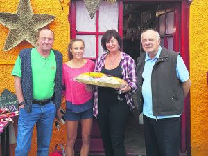 Michell Finn and her father Toddy being presented with a hamper by Liam Sheehan and daughter Deirdre before joining up with the Ireland team for the 2016 Olympics in Rio.