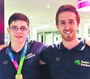 Cadan McCarthy, who wil swim for Ireland at the Schools' Games in the UK this weekend, pictured with coach Cormac Powell.