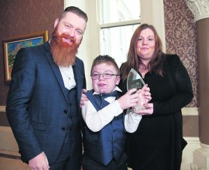 Billy Kiely, BT Child Hero, pictured with his parents Will and Christine after receiving his award.