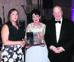 Rose Hynes, chair of Shannon Group presenting the Mid-West Media Merit award to Caroline McNamara, wife of the late jockey JT McNamara, with Minister for Finance Michael Noonan